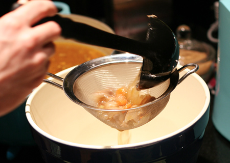 Straining the homemade chicken stock