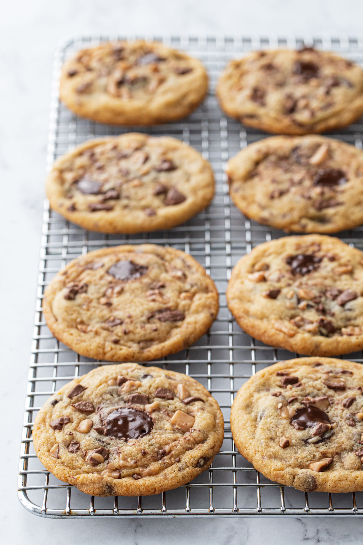 Rows of Toffee Chocolate Chip Cookies on a wire cooling rack.