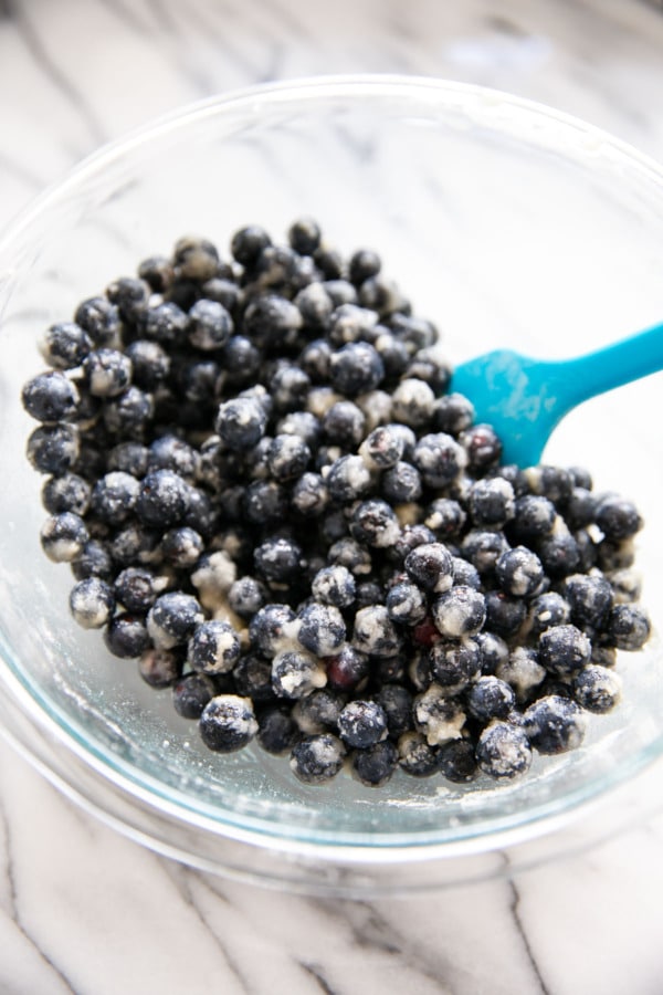 Bowl of fresh blueberries tossed with sugar and flour.