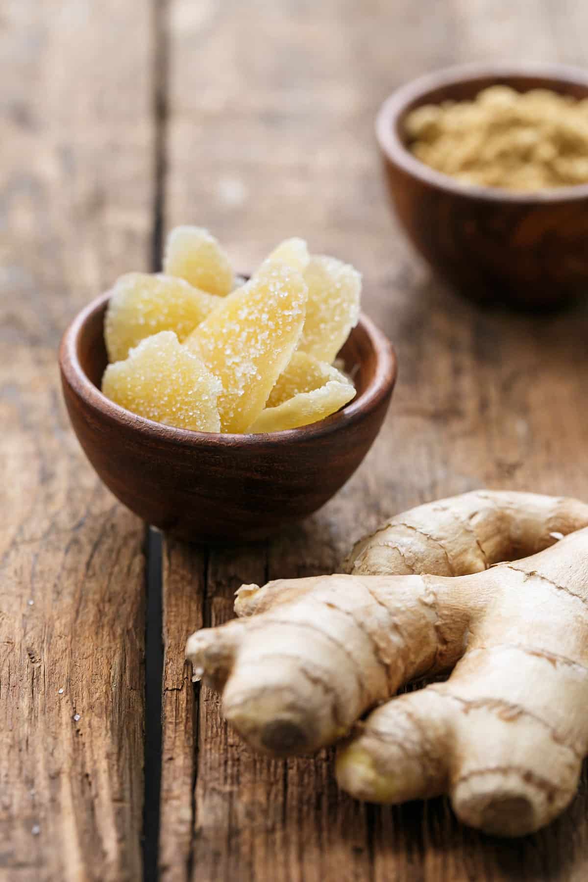 The three kinds of ginger used in these gingersnaps, including fresh ginger, a bowl of crystalized/candied ginger, and a bowl of ground ginger.