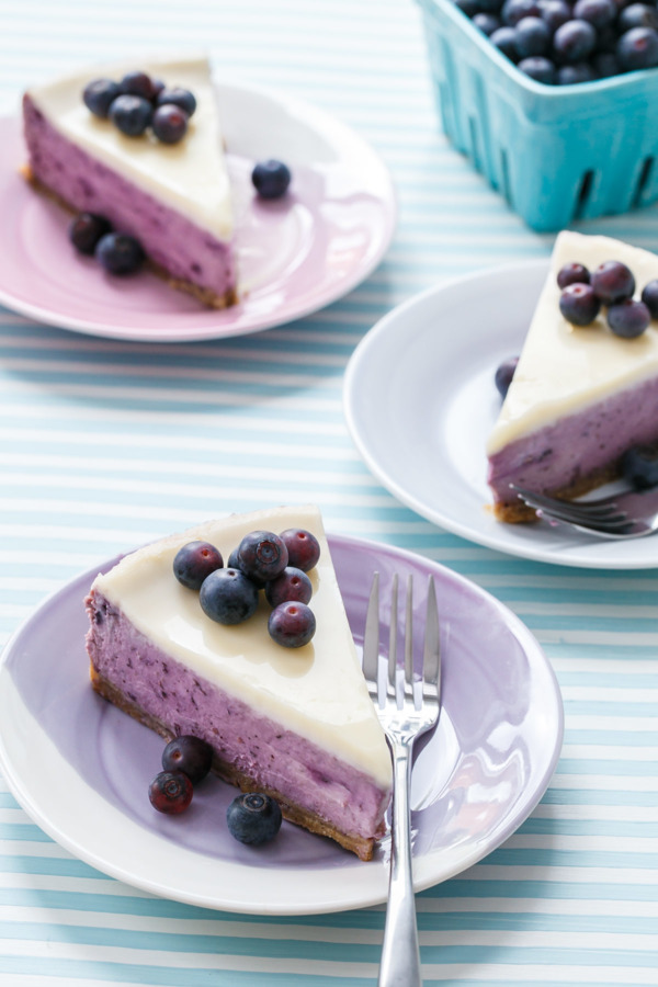 Vibrant purple blueberry cheesecake, made with roasted blueberries and a creme friache glaze.