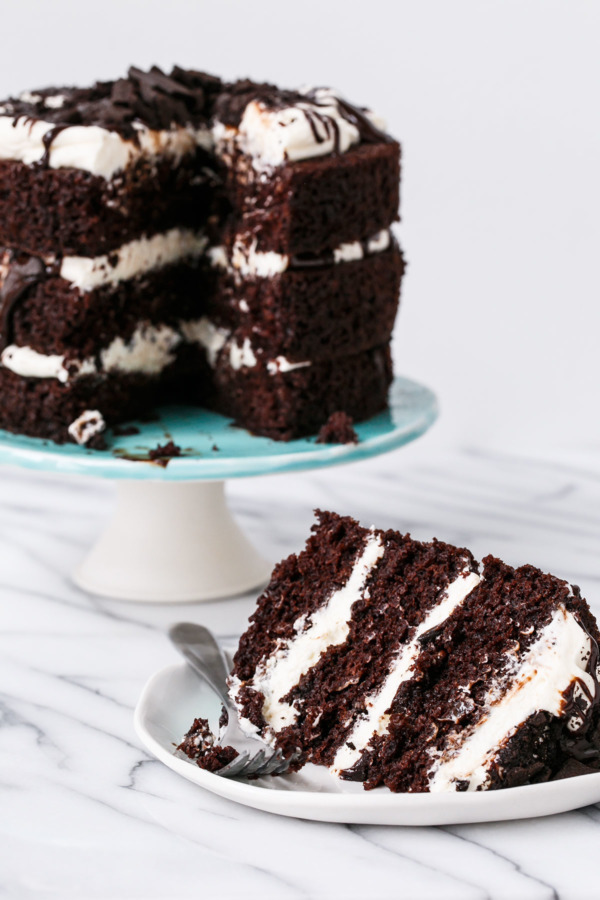 Slice of Kentucky Mudslide Chocolate Cake, layered with bourbon whipped cream and fudge sauce.