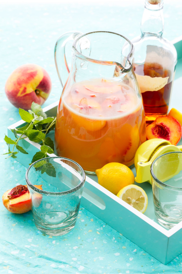 Bourbon Peach Lemonade Punch with fresh peaches and mint