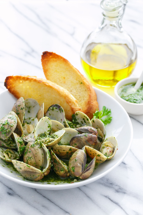 Mojo Clams steamed in garlic, olive oil, and white wine and tossed with a green 'mojo' sauce made with cilantro and parsley.