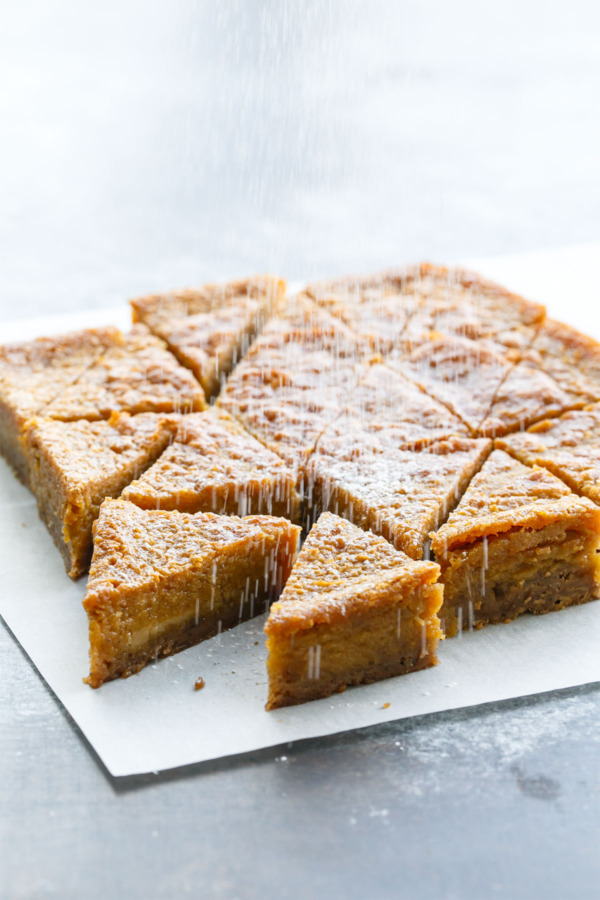 Pumpkin Chess Pie Bars topped with powdered sugar