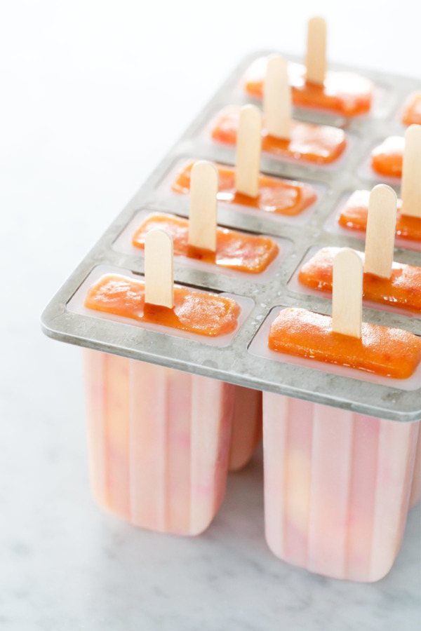 The perfect summertime treat recipe: whole peach popsicles with rosé wine!
