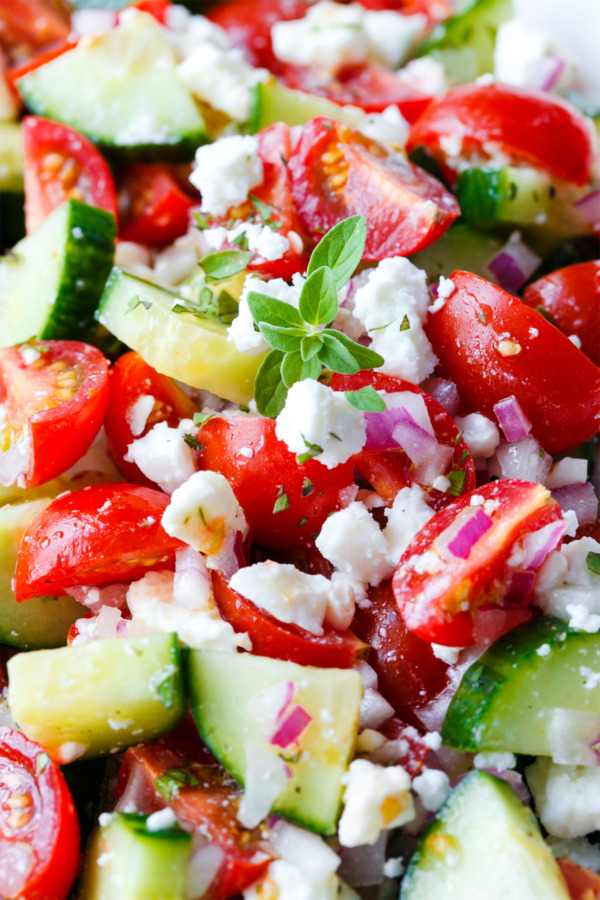 Quick Summer Salad with cucumber, tomato, red onion, oregano, and feta cheese.