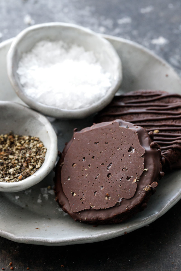 The Best Chocolate Sable Cookie recipe, dipped in dark chocolate and sprinkled with salt and pepper (yes, pepper!)