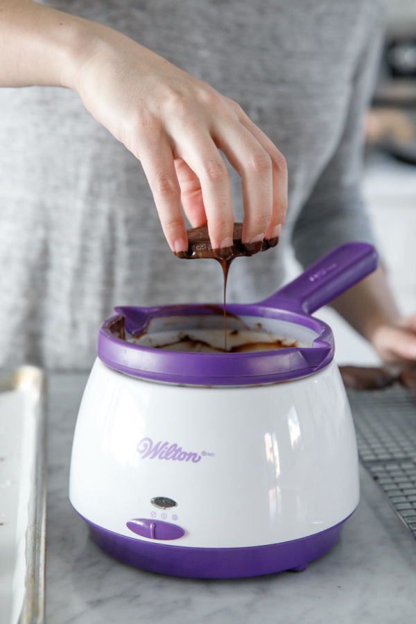 Dipping and drizzling cookies in chocolate for a delicious recipe!