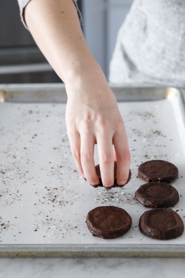 Cookies get dipped in chocolate, flake sea salt, and black pepper.