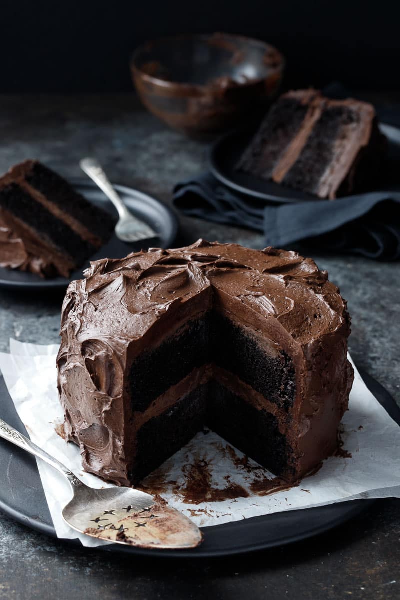 Dark, fudgy and ultra-moist chocolate layer cake slathered with a dark choc...