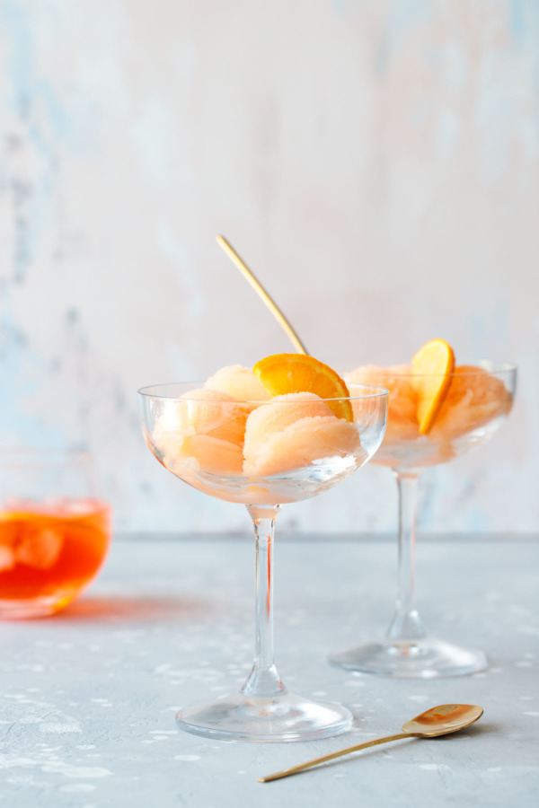 Boozy spritz sorbet recipe, with aperol, prosecco and orange juice.