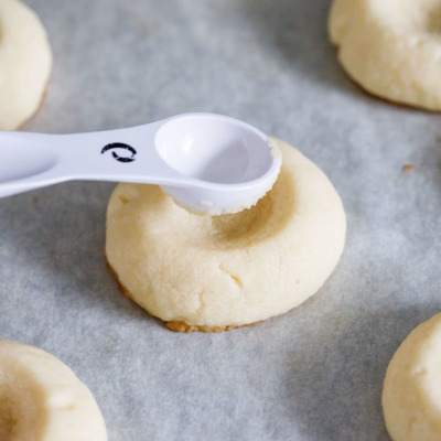 How to make the perfect shortbread thumbprint cookies - press them down again after baking to deepen the imprint.