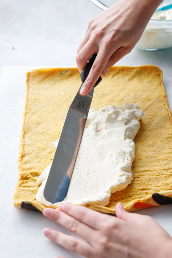 Once the cake roll is cooled, carefully unroll it and add the mascarpone filling.