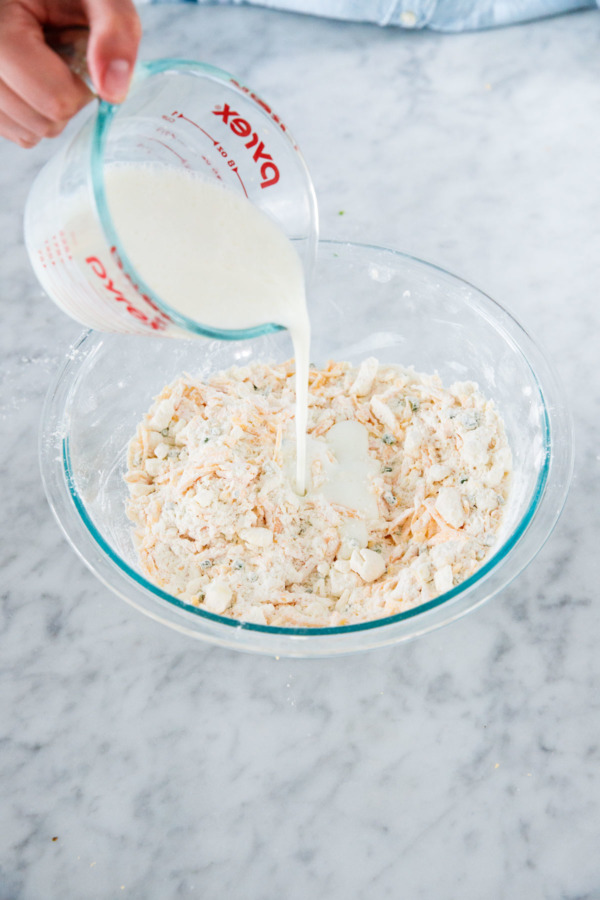 How to make buttermilk biscuits from scratch: pour in buttermilk, then stir with a fork until just moistened.