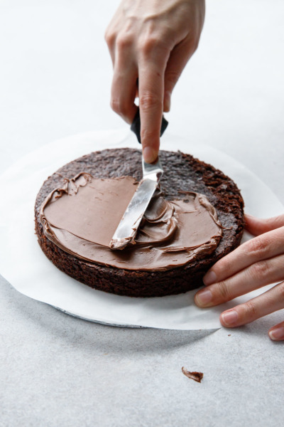 Spread a thin layer of nutella on top of brownie.