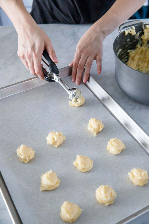 How to make homemade Gougères (cheese puffs): scooping the dough is easier than piping it, but makes for more rustic shapes.