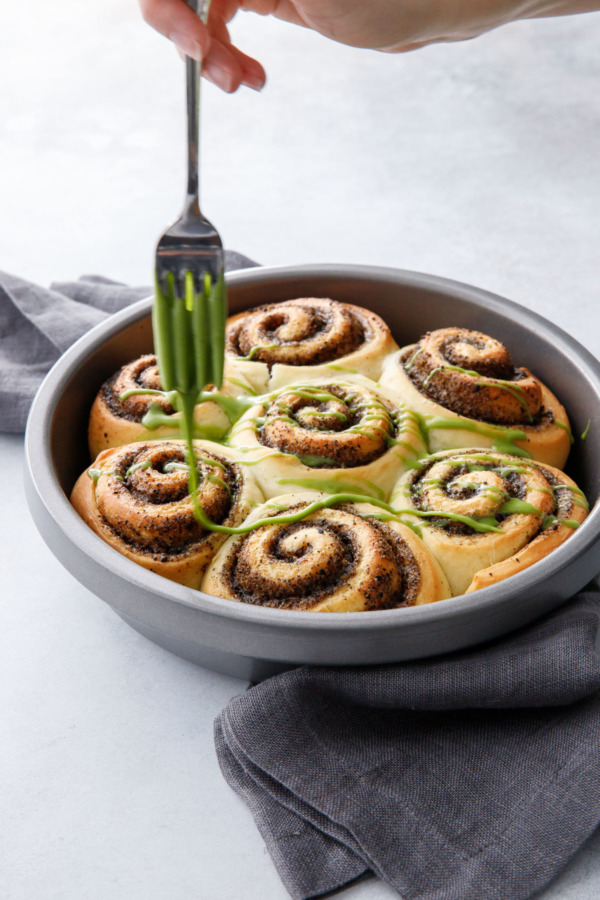 Black Sesame Cinnamon Rolls drizzled with a sweet matcha glaze