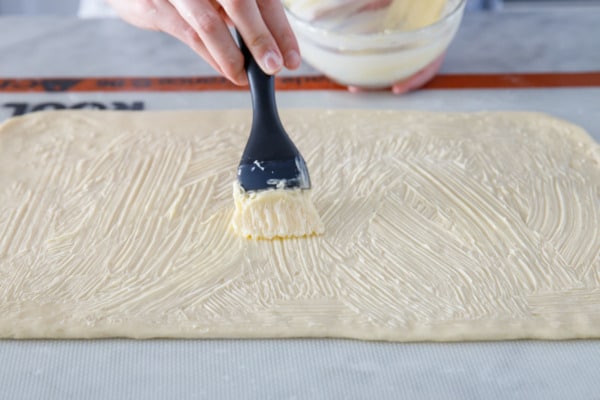 Brush the dough with very soft butter (not melted).