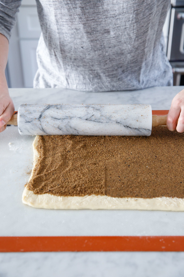 Use a rolling pin to compress the filling.