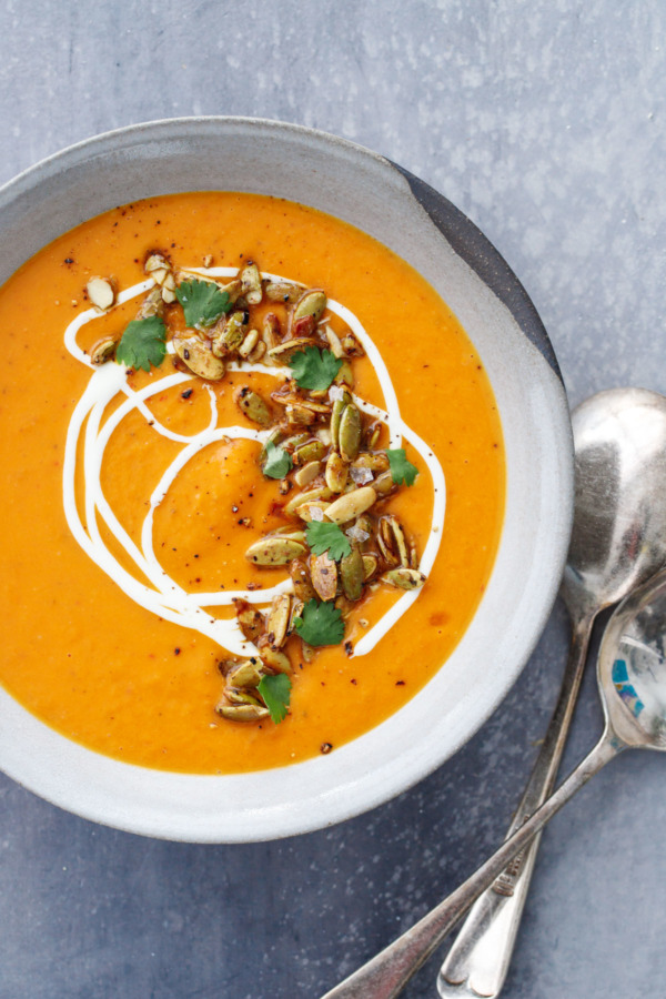 Bowl of creamy butternut squash soup, flavored with orange and saffron.