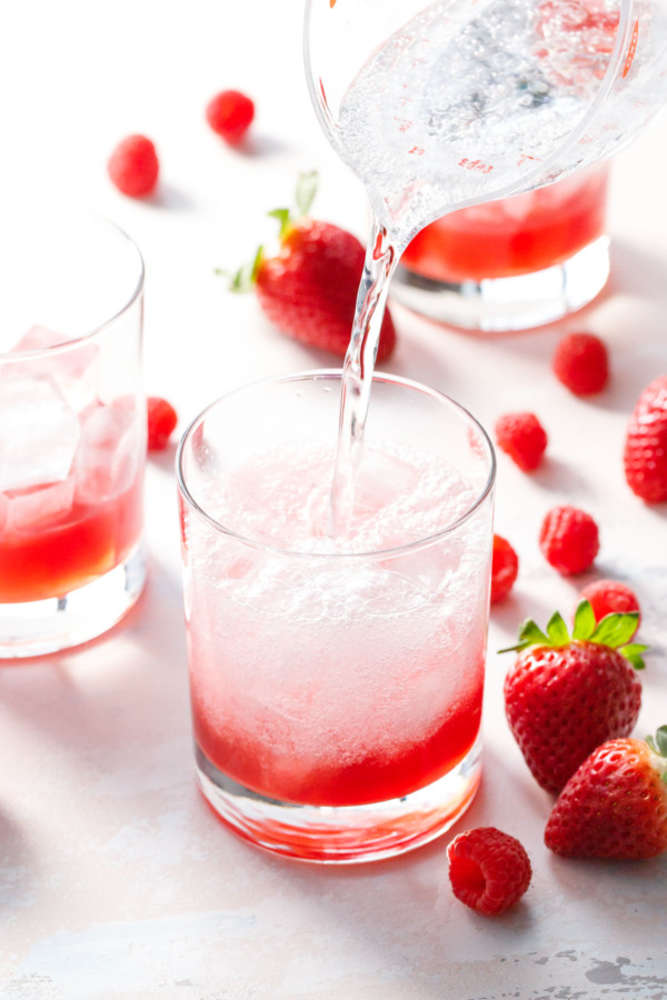 Top a homemade fruit shrub with sparking soda for a unique and flavorful mocktail recipe!