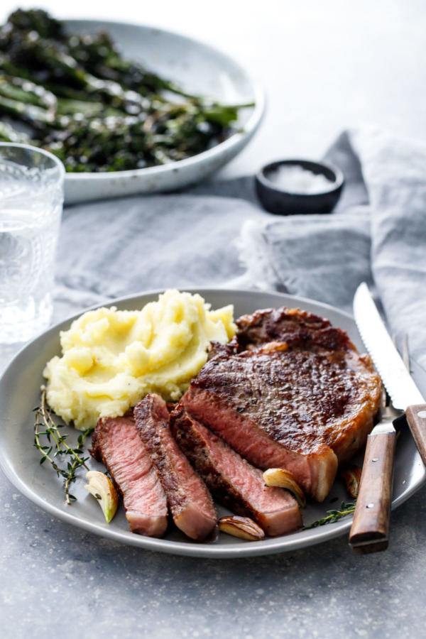 How to Cook Reverse-Sear Steaks - serve with mashed potatoes and crispy oven-roasted broccolini
