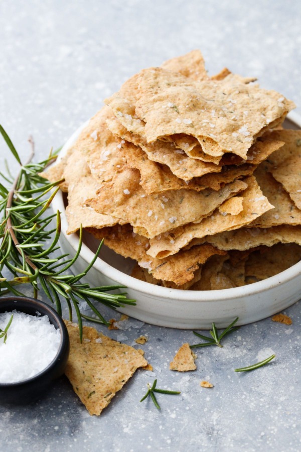Homemade sourdough cracker recipe with olive oil and herbs stacked in a bowl. 