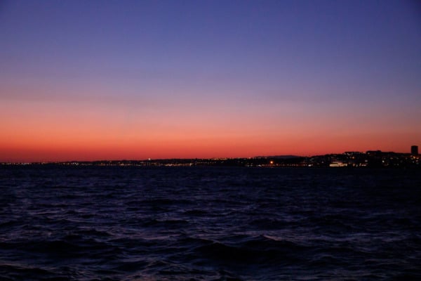 Sunset view of Lisbon, Portgual from a boat on the Tagus river.