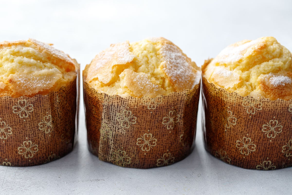 Three Portuguese rice muffins (also called Bolos de Arroz) in a horizontal row.