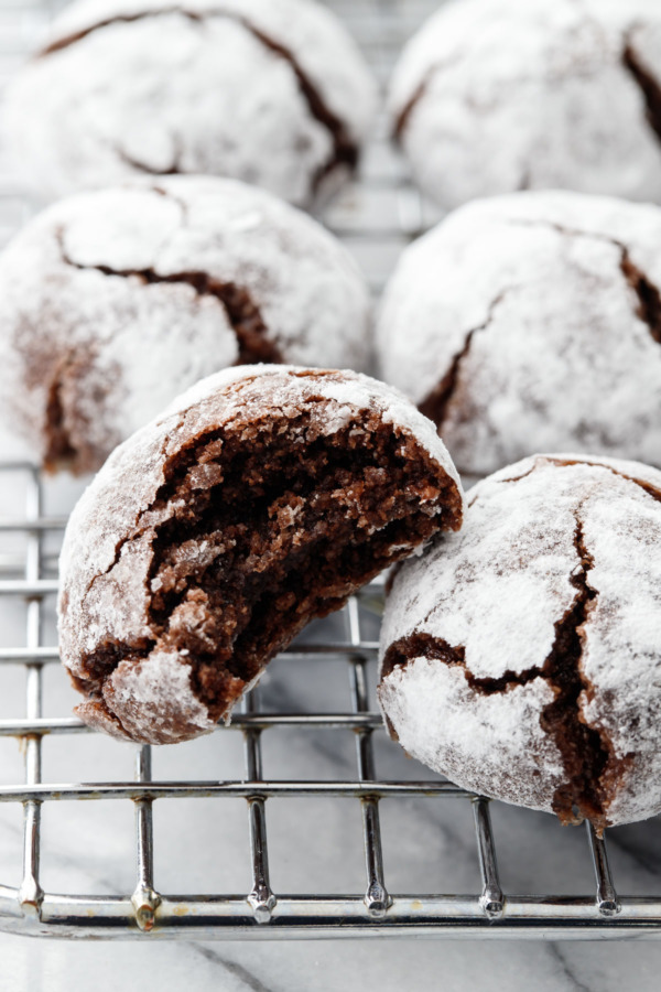 Close up of a Chocolate Amaretti Cookie with a bite taken out of it, showing the rich chocolate inside.