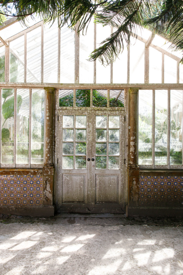 The greenhouse in the Pena park, with dusty windows filled with scrawled names.