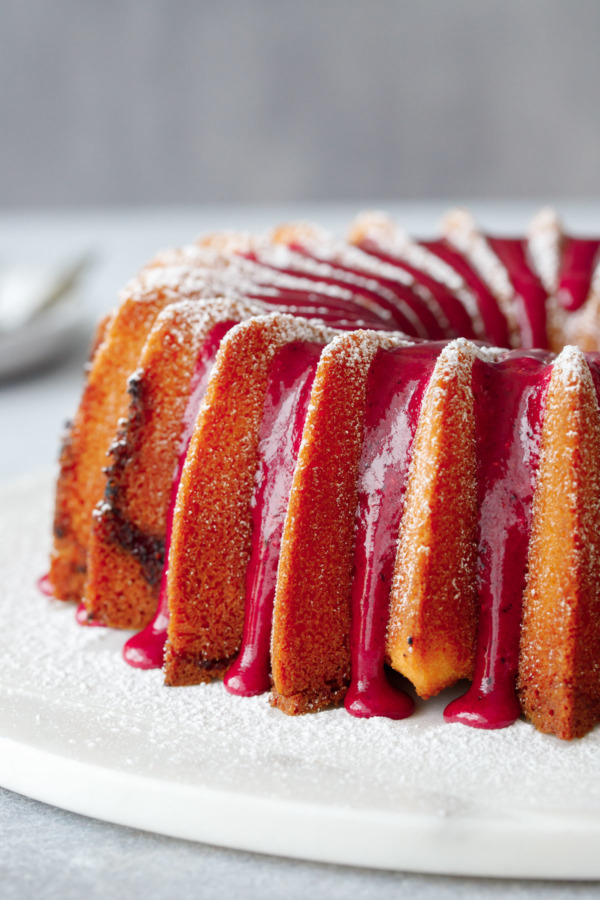 Side angle showing the drips of glaze down the sides of a bundt cake.