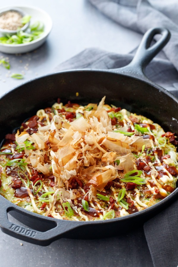 Cabbage & Zucchini Okonomiyaki, cooked in a cast iron skillet and topped with bonito flakes