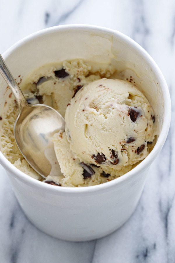 Carton of Banana Fudge Chunk Ice Cream with a scoop and a spoon.