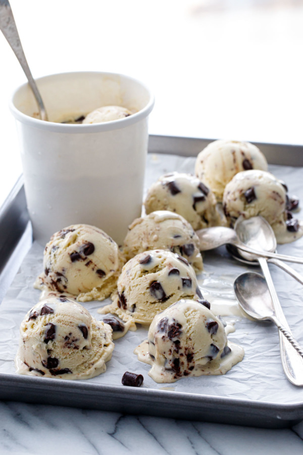 Sheet pan with scoops of Banana Fudge Chunk Ice Cream and a partially-full carton.