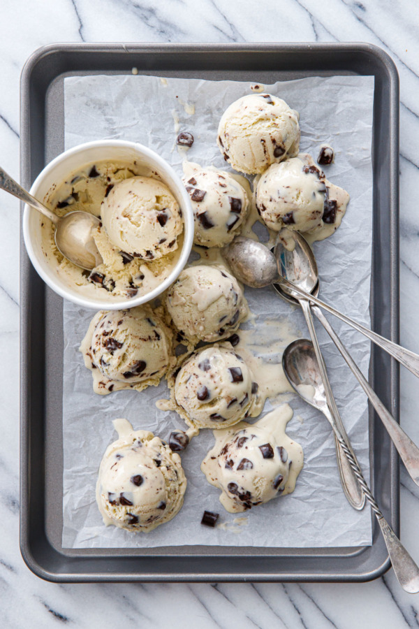 Overhead shot of partially melted scoops of Banana Fudge Chunk Ice Cream.