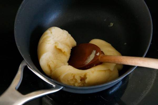 Making choux pastry dough for cream puffs - cook the dough until it comes together.