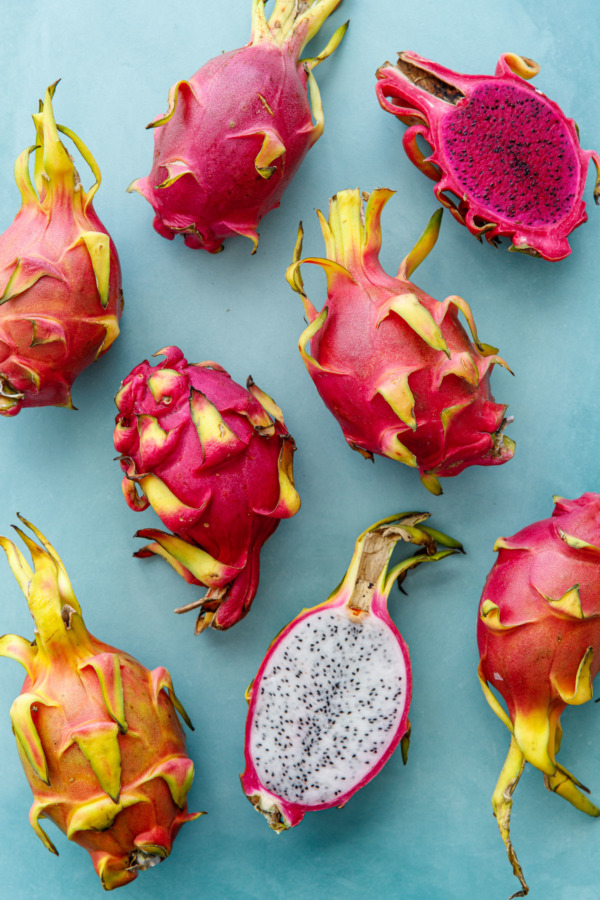 Pink and white dragonfruit on a turquoise background