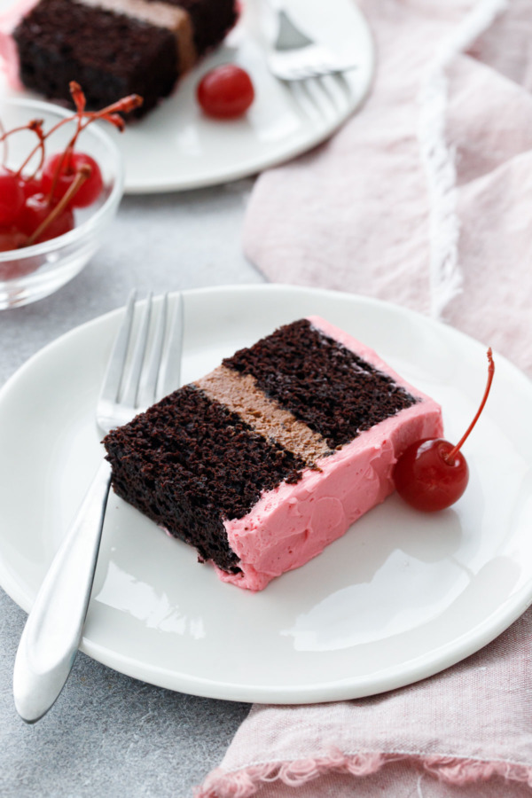 Rich chocolate cake with a layer of chocolate cherry buttercream in the middle, and frosted with pink maraschino buttercream.