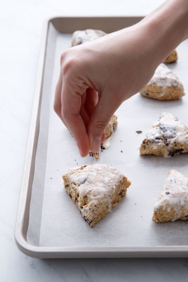 Brush scones with cream and sprinkle with raw sugar.