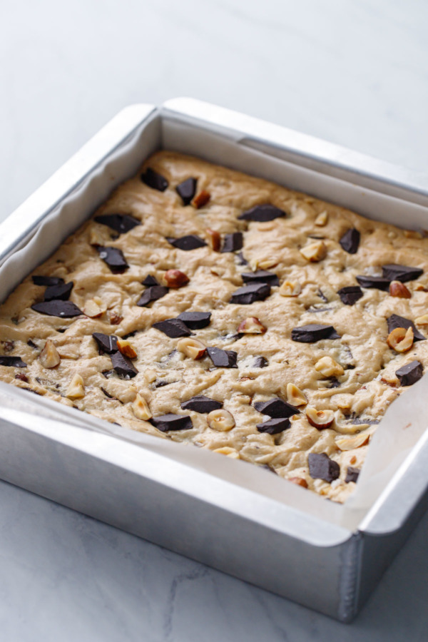 Square baking pan with nutella-stuffed blondies after baking.