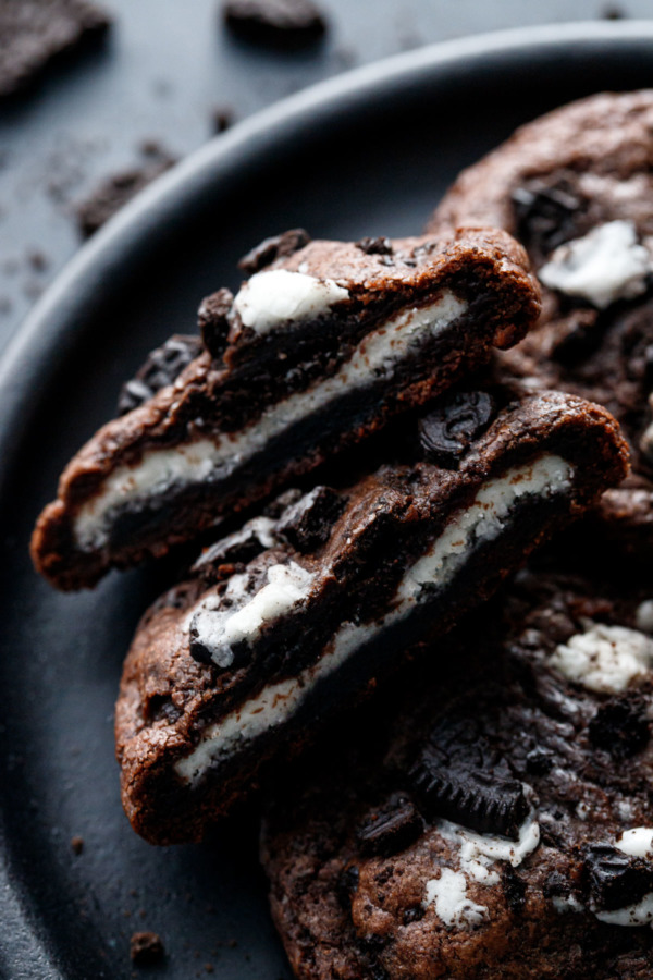 Closeup of a Chocolate Cookies 'n Cream Cookie cut in half to show the cream filling stuffed inside.