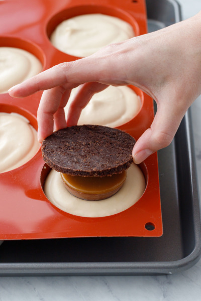 How-To Entremet Cake Process: place a round of chocolate pecan crust on top.