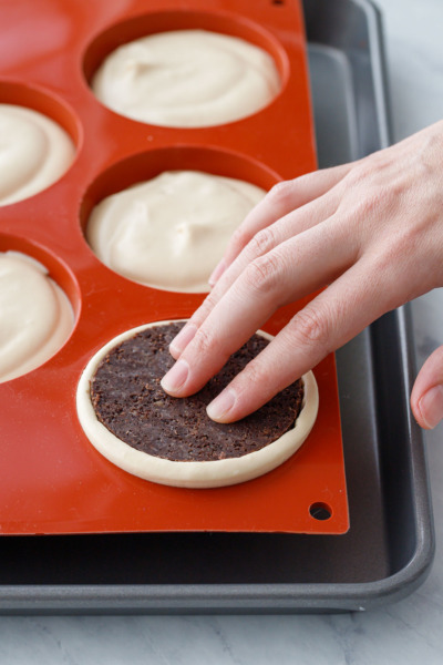 How-To Entremet Cake Process: press down until the crust is level with the top of the mold.