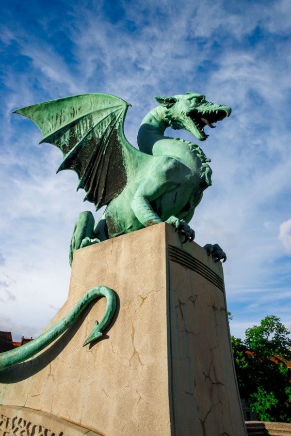 Green patina dragon statue guarding the Dragon's Bridge in Ljubljana, Slovenia