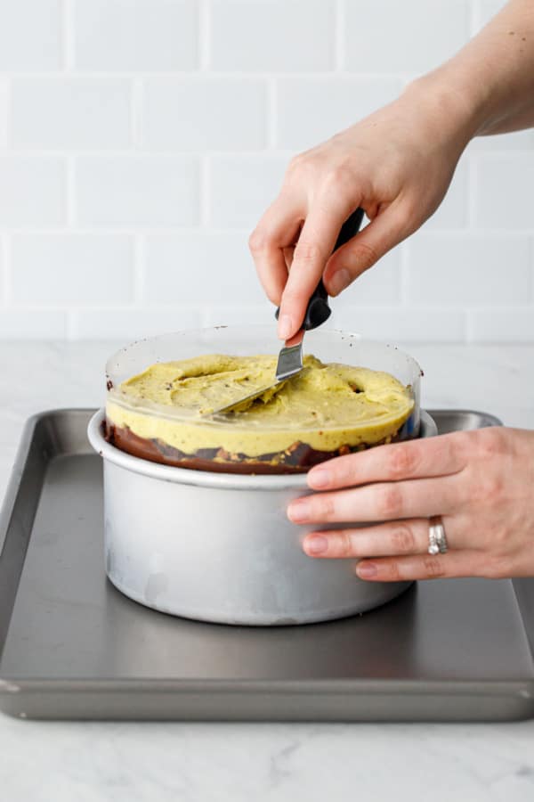 Assembling a naked cake: the acetate holds in the cake and frosting layers.