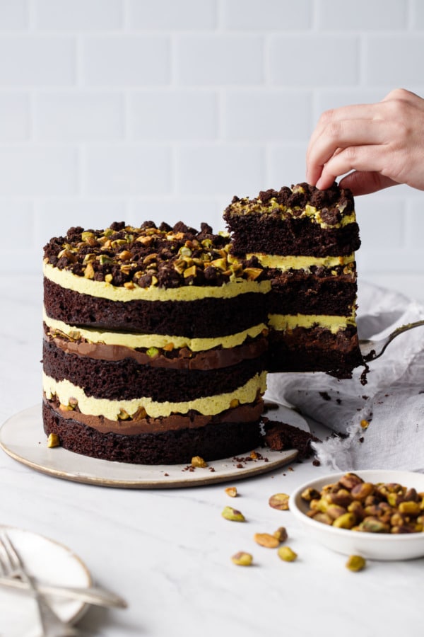 Cutting a slice out of the Dark Chocolate Pistachio Naked Layer Cake