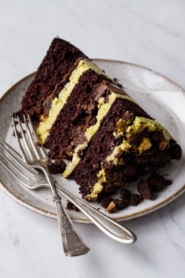 Closeup slice of Dark Chocolate Pistachio Naked Layer Cake