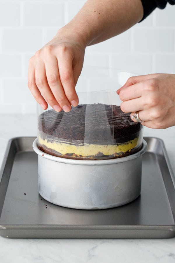 Assembling a naked layer cake: when it gets too tall, add another layer of acetate.